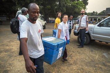 At their base camp on the first day of a massive immunisation campaign, Medecins Sans Frontieres (MSF) staff load vehicles with coolers containing the yellow fever vaccines that are to inoculate peopl...