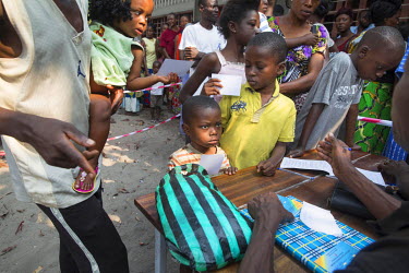 A medical worker registers children for yellow fever vaccinations at a school in the Zone de Sante Kikimi.  Following an outbreak of mosquito-borne viral infection, Medecins Sans Frontieres (MSF) deci...