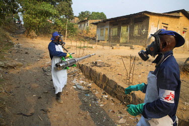 A member of Medecins Sans Frontieres (MSF) staff fumigates with an insecticide, to kill mosquitos, in an area where there have been confirmed cases of yellow fever.