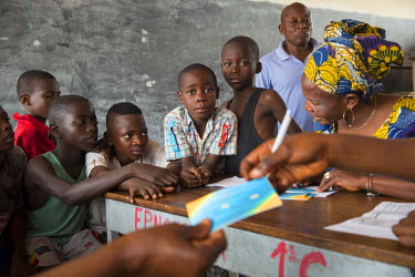 A medical worker registers children for yellow fever vaccinations at a school in the Zone de Sante Kikimi.  Following an outbreak of mosquito-borne viral infection, Medecins Sans Frontieres (MSF) deci...
