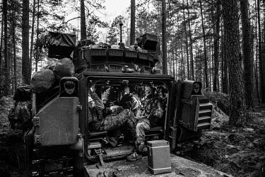 US Army soldiers rest after spending the night in a tank during NATO Iron Sword joint exercises.