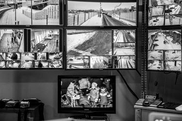 CTV screens in the situation room of the border checkpoint with Russia. At the bottom a television set broadcast the news on the refugee crisis.