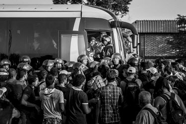 A group of refugees crowding onto one of the few available buses taking them to various destinations as they seek to travel onto Western Europe.