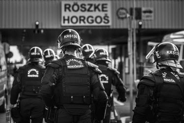 Riot police heading to the border crossing with Serbia to confront refugees trying to get into Hungary from Serbia, after Hungary closed its border with Croatia.