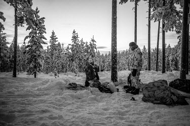 Two Border Guards recruits wake up after spending their first night outdoors in the forest, enduring temperatures dropping to minus 30 Celsius during a training exercise.