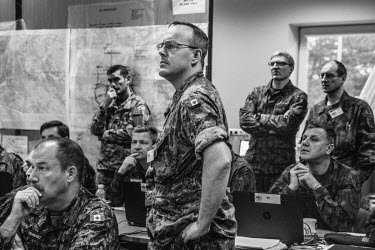 Captain Hardie, from the Canadian Army, with other officers in the situation room during NATO Iron Sword joint exercises.