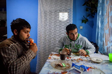 Michal (22) and Emil (20) having a coffee and cigarettes in Emil's newly built the new house which was funded by a micro-loan aimed at the local Roma community.