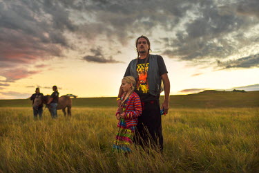 Protectors of the water gather around the river near the Sacred Stone Camp to welcome arriving tribes who have come by canoe to show their support. In April 2016 the Standing Rock Sioux Tribe began a...