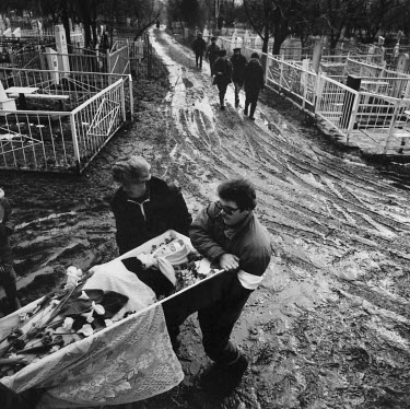 A burial at the local cemetery. Due to the harsh economic conditions after the collapse of the Soviet Union most people could not afford a relegious burial and had to make their own arrangements.