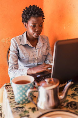 Aspiring tech professional Linda Kobusinge works on her laptop in a cafe in central Kampala.