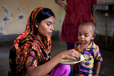 Tania feeds one of her three children (Robiul, two years old.) at the Radda Maternal Child Health & Family Planning (MCH-FP) centre, where two of her children have been treated for malnutrition.