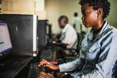 Linda Kobusinge, who hopes to pursue a career in the tech industry, at work in an internet cafe in central Kampala.