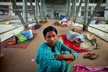 Parvin Akhtar sits on the jetty where she currently lives at Shadarghat Boat Terminal in Dhaka.