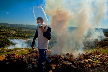 A man in a homemade gas mask at the weekly demonstration, held by Palestinian activists and their suppoters in Bilin (Bal'in), protesting at the construction of the Israeli Separation Wall, that cause...