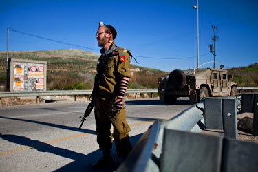 A religious soldier hitch-hiking on the road to Yitzhar, an Israeli settlement located in the Samarian mountains near Nablus. Over 130 families, over 500 people, live in the Orthodox Jewish community....
