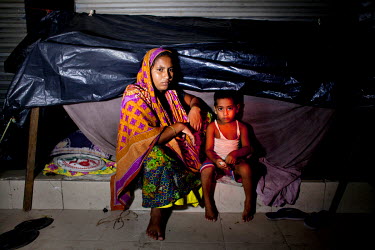Amena and her daughter, Ishma, prepare to bed down for the night in their makeshift shelter on the pavements of Panthakunja.