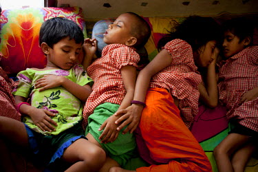 Fatema (not visible ) and her children sleeping on the floor at the Manik Nagar PDC (Pavement Dweller Centre) in Dhaka.