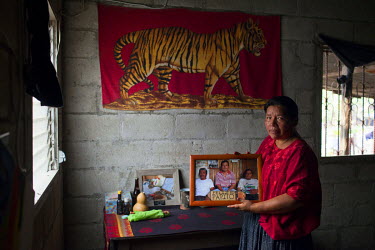Angelica Choc, standing in her son's bedroom, holds a photograph of her husband, former Q'eqchi' Mayan community leader, teacher and anti-mining activist Adolfo Ich Chaman. Ich Chaman was murdered on...