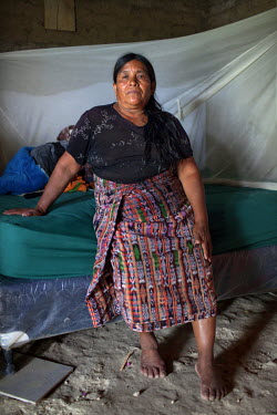 Patrocinia Sanchez Chen, 57, survivor from the Rio Negro massacres, sits on her bed at her home. Patrocinia hopes the Forensic Anthropology Foundation of Guatemala (FAFG) identifies and returns the re...