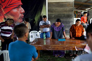 Angelica Choc, surrounded by local leaders from other communities resisting mining activities in the area, leads a prayer in remembrance of her slain husband, former Q'eqchi' Mayan community leader, t...