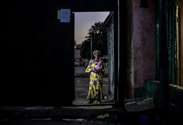 Oumou Barry by the gate where she was attacked while fleeing the massacre at the stadium during the massacre of 28 September 2009.'I was beaten with a rifle butt and kicked as I tried to escape the st...