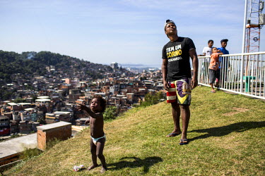 People fly kites from the Palmeira cable car station in Complexo do Alemao in the North Zone.