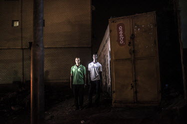 Amadou Dioulde Barry (right) at the spot where he and his friend, Thierno Mamadou Balde, were arrested and subsequently tortured on 23 October 2010.'It was Saturday 23 October 2010. Red Berets soldier...