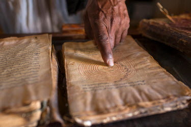 Mohamed Ould Ghoulan, curator of the Habot Library, points to a page in an ancient manuscript on astronomy in which the position and orbit of the planets described. The paper on which are written thes...