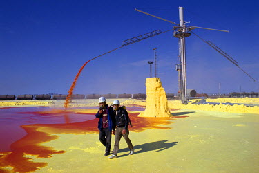 Men working in a sulfur pit at Chevron's Tengiz oil operation, part of a joint venture between the United States, Russia and Kazakhstan, wear protective breathing aparatus.