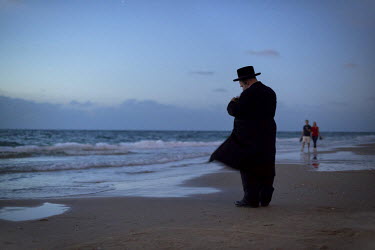 An Ultra-Orthodox Jewish man prays during a 'Tashlich' ritual beside the Mediterranean Sea. 'Tashlich' ('to cast away') is a ritual where believers go to a flowing body of water and symbolically 'thro...