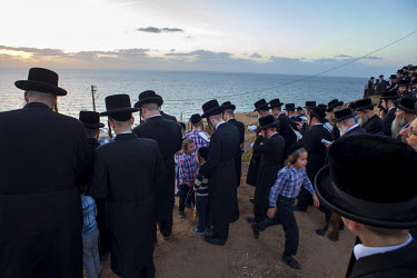 Ultra-Orthodox Jewish men and boys praying during a 'Tashlich' ritual beside the Mediterranean Sea. 'Tashlich' ('to cast away') is a ritual where believers go to a flowing body of water and symbolical...