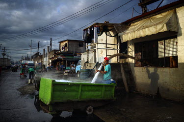 A worker fills a cart with crushed ice at one of the markets in the Navotas Fish Port, the largest fish port in the Philippines. The markets at Navotas Fish Port trade in fish and other seafood from M...