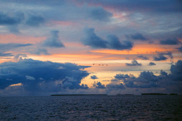 A sunset over Fakaofo Atoll in Tokelau.  Tokelau is a 'non-self-governing territory' administered by New Zealand. It is located between Hawaii and New Zealand and has a total population of approximate...