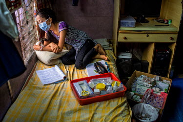 XDR-TB patient Nischaya, at home in the Ambedkar Nagar area of Mumbai, with her TB medication.  Nischaya (not her real name) is 18 years old, lives in Mumbai, and is one of only a handful of extensive...