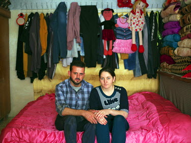A young Yazidi couple, Rahad and Julia, in their home in the Sharia district near Dohuk. They fled Sinjar mountain when ISIS attacked their villages in August 2014. Both their families came to the Sha...