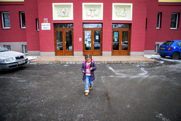 Esther Kroscenova, six, leaves the ZS Chrustova elementary school after taking an enrollment examination for the school where Roma and non-Roma children are educated together. She is holding a small g...
