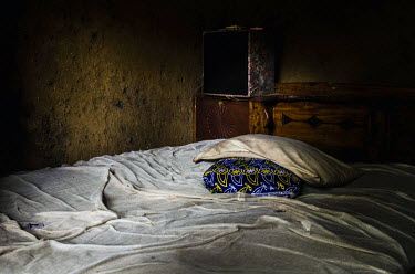 The bedroom of an Ebola victim in Njala Ngiema village. The families of Ebola victims are often too afraid to go inside the rooms of the deceased, so they remain untouched, frozen at the moment of dea...