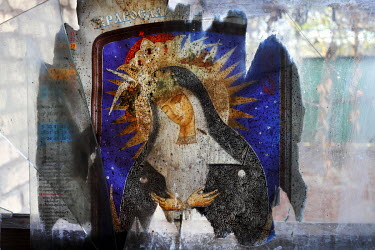 A religious picture placed covers a broken pane of glass in the entrance to a house in the village of Dacha (previously Popovskie Dachi).