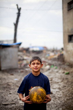 A boy with a football in the Roma settlement on 'Budulovska Street', a segregated community where around 800 people live,