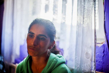 Zlatice, who is the mother of five children, inside a house in the centre of the Roma settlement of Podsadek.