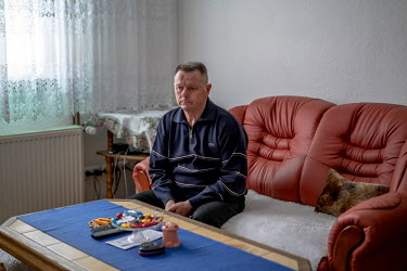 Fikret Bacic in his home. 29 members of his extended family were taken by Bosnian Serb forces and killed in July 1992. He is still searching for the remains of most of them.