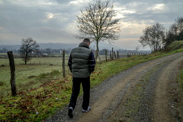 Fikret Bacic walks near his home along a path that leads to a part of the hamlet where most of his family members were killed during the Bosian war. 29 members of his extended family were taken and ki...
