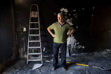 Hassan Dara in his burnt out wedding and photography business. It was destroyed by ISIS during their occupation of the city.
