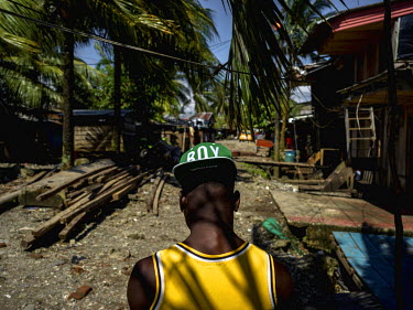 A young man walking through Puente Nayero, a slum area home to more than 1200 families. An estimated 95 percent of the residents have been forcibly displaced from their original homes due to the confl...