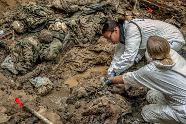 Sharna Daley (top), a Forensic Archeologist from England and Renee Kosalka (bottom), a Forensic Anthropologist from Canada, both working for ICMP (International Committee for Missing Persons) exhume t...