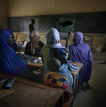 Women at a literacy class. Many of the women in the class are mothers who have returned to education after having children.