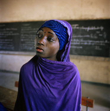 A woman attends a literacy class. Many of the women in the class are mothers who have returned to education after having children.