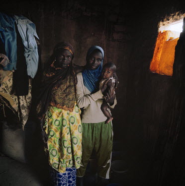 Aichatou Abdou, 17, with her mother and her one year old baby, Mahamadou Moussa. Two years ago in an arranged marriage she wed a 47 year old policeman. In the beginning she says her husband was nice b...