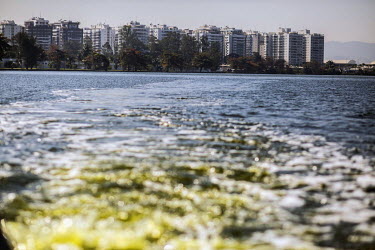 A boat's propellers stir up contaminated water, in Lagao da Jacarepaqua, near the 2016 Olympic Park, revealing a flourescent green colour caused by sewage and other pollutants.Two decades of developme...