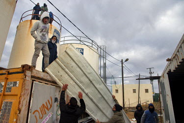Youths prepare to barricade themselves on water towers in the Jewish outpost of Amona. The Israeli high court ordered the state to remove the unauthorised outpost as it sits on privately-owned Palesti...